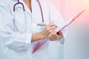 Close,Up,Of,Patient,And,Woman,Doctor,Taking,Notes.,Woman