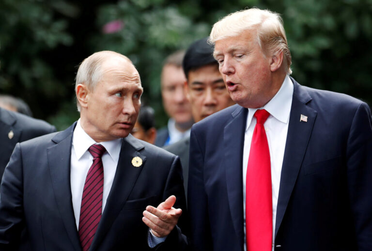 FILE PHOTO: U.S. President Donald Trump and Russia's President Vladimir Putin talk during the family photo session at the APEC Summit in Danang