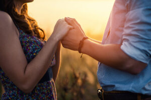 Holding Hands Loving Couple Stands In The Middle Of The Wheat Fi